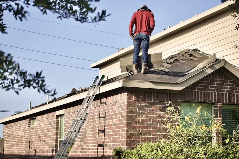 Professional roofer working on a residential roof in Orange Court